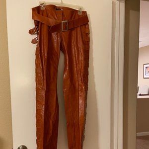 Women's Chestnut brown leather pants with buckles.